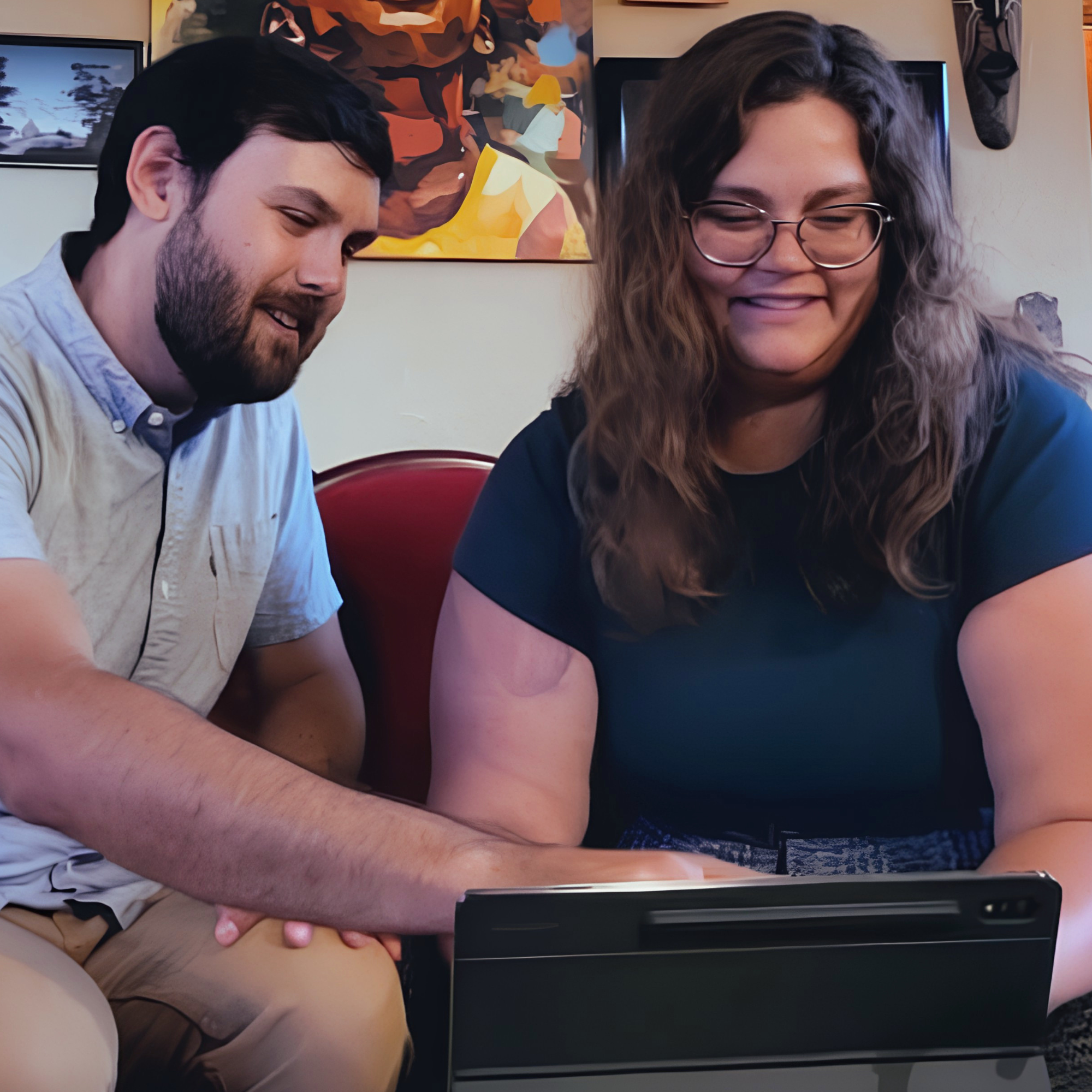 Two people collaborating to set up a new tablet, demonstrating a simple and seamless device onboarding experience.